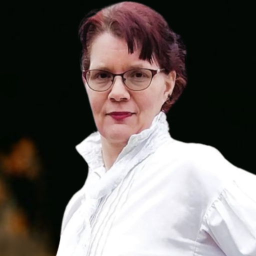 A red-haired person in middle age with their hair up in a bun.